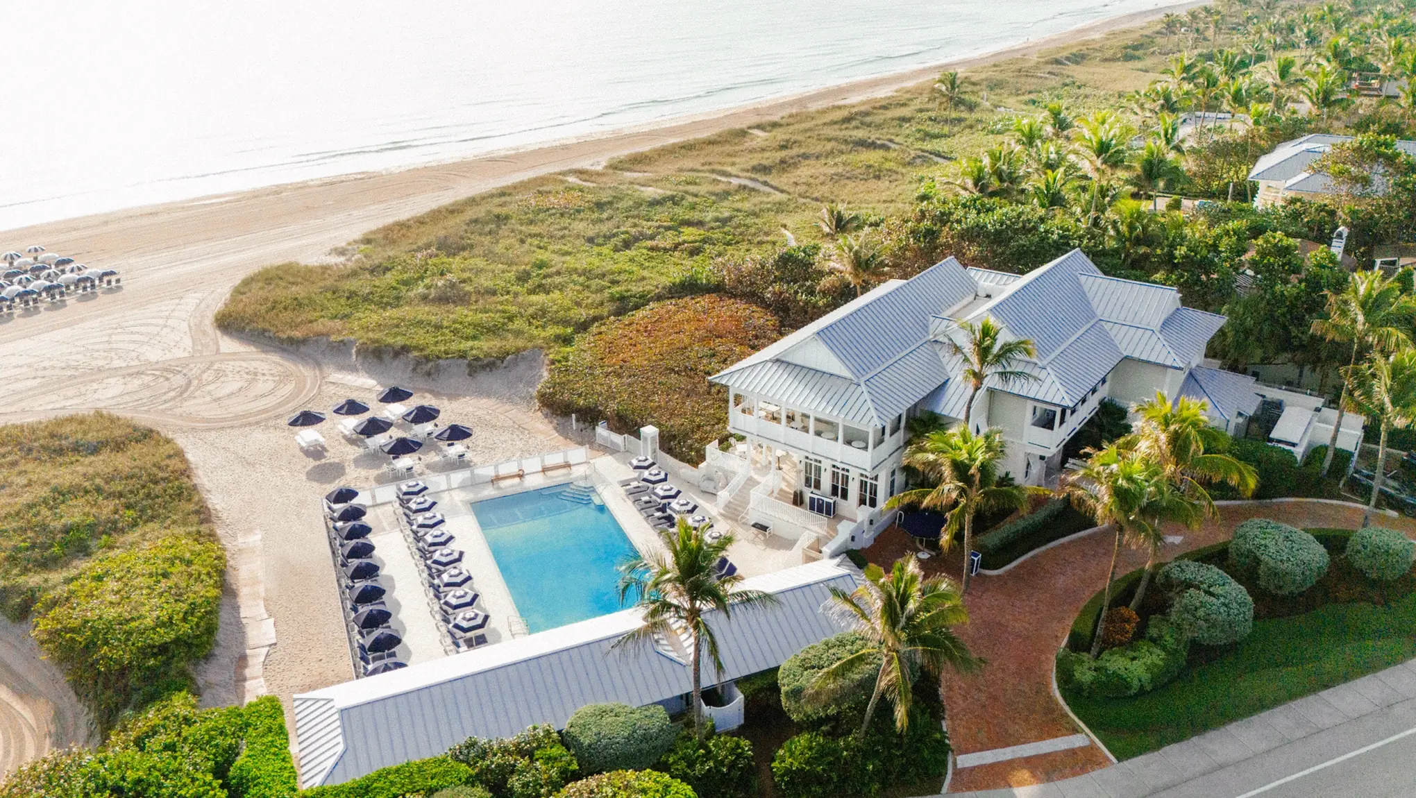 Aerial view of The Seagate Beach Club showing the clubhouse, pool, and private beachfront in Delray Beach