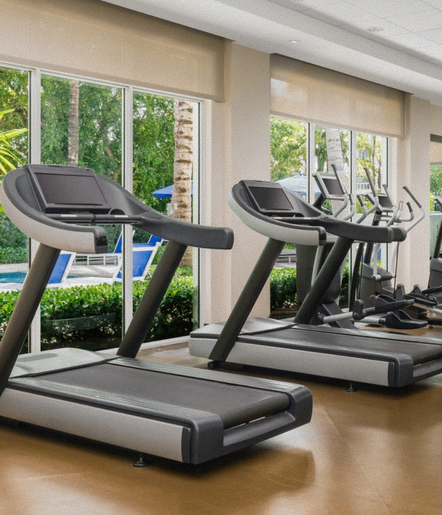 Treadmills, ellipticals, and weight equipment in the bright fitness center at The Seagate Delray Beach