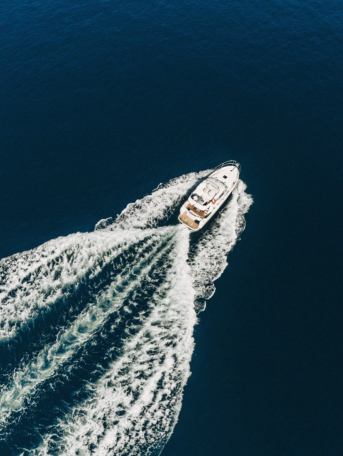 Aerial view of a YachtHampton yacht cutting through open ocean water